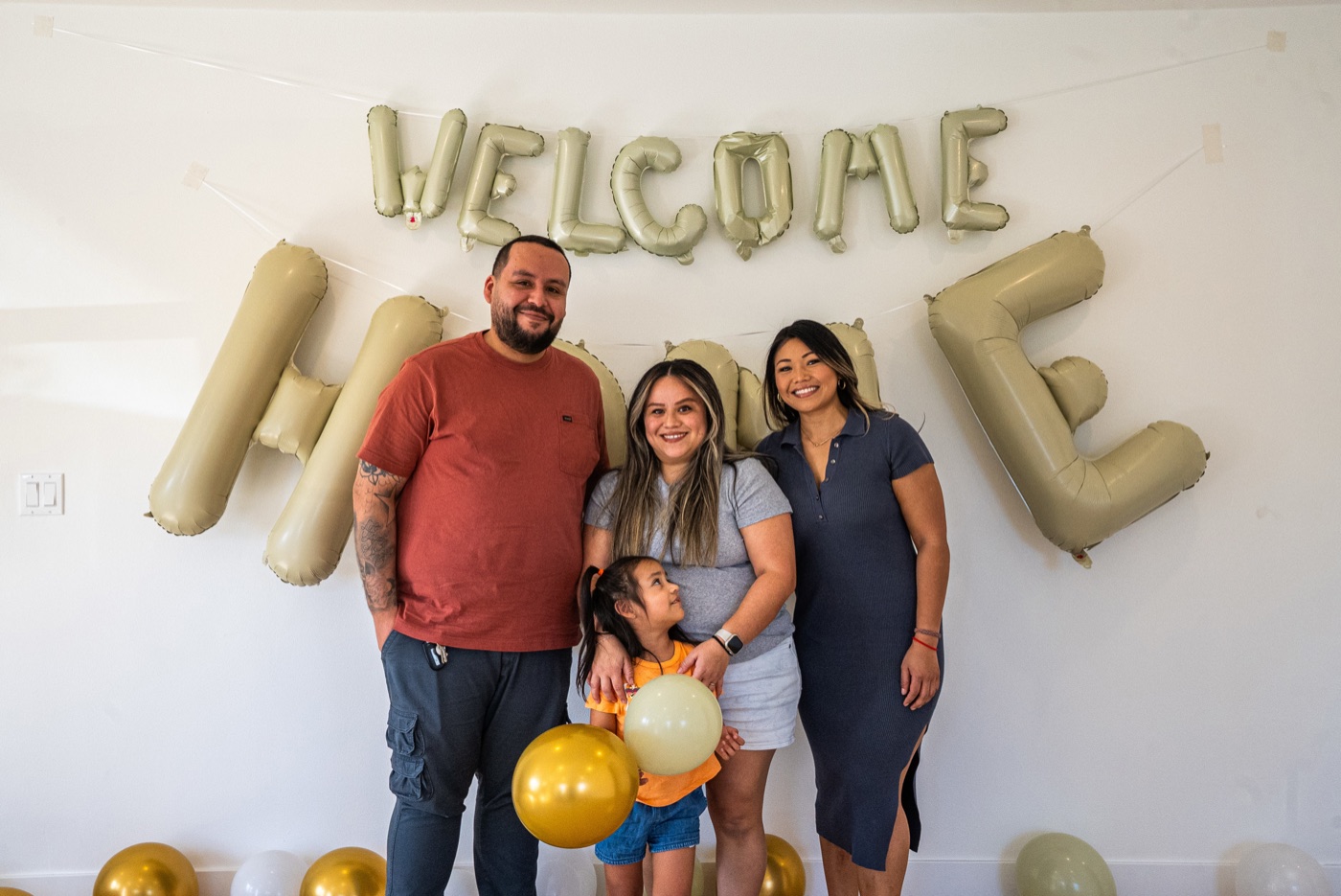 Family and Dianna celebrating closing day with welcome home balloons